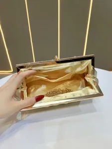 Elegant gold rhinestone evening clutch bag featuring chain strap and luxury satin lining.