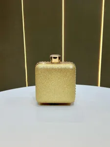 Gold glitter box clutch handbag evening bag with crystal clasp detail for formal party.
