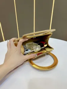Gold rhinestone evening bag for women, elegant luxury handbag with round handle and chain.