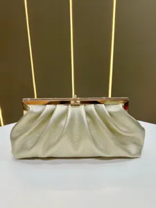 Gold pleated evening clutch bag featuring a metallic frame and sparkling rhinestone clasp detail.