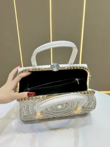 Luxury rhinestone evening bag detail, white crystal handbag with metal clasp and inner pocket