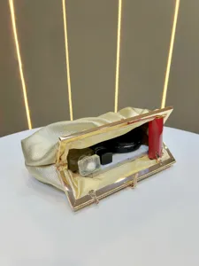 Elegant gold rhinestone evening clutch bag with metal frame showing interior capacity.