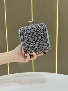 Stunning rhinestone evening clutch detail, sparkling crystal rhinestones and sleek metal clasp.