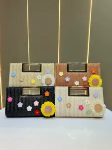 Handwoven straw clutch bag with metal handle and cute floral crochet decorations for women.