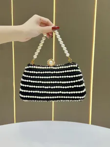 Elegant black woven pearl evening clutch bag with beaded handle and elegant clasp detail.