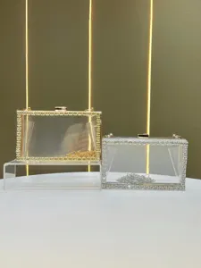 Clear acrylic rhinestone clutch bag detail, gold and silver evening bag with chain strap.