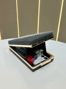 Elegant black rhinestone evening clutch bag with gold metal trim for party and wedding events.