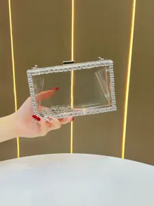 Clear acrylic evening clutch handbag with sparkling rhinestone crystal trim and metal chain detail.