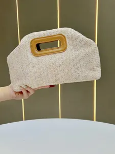 Stylish straw woven clutch bag for women, beige woven handbag featuring brown leather handle.