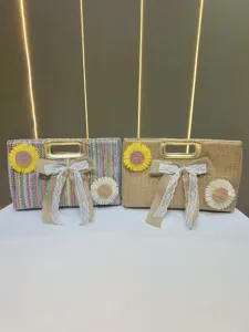 Detailed view of woven straw handbags featuring colorful stripes, lace bows, and floral charms.