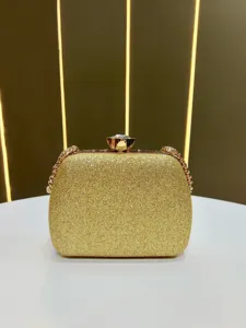 Elegant gold glitter evening clutch bag with crystal clasp and chain strap for women.