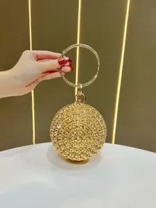 Exquisite gold spherical evening bag detail, sparkling rhinestone rose design, elegant circle handle.