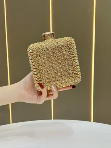 Gold rhinestone evening clutch bag detail showing sparkling crystals and elegant clasp closure.