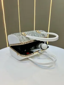 Luxury rhinestone barrel handbag detail view, exquisite gold trim and evening purse craftsmanship.