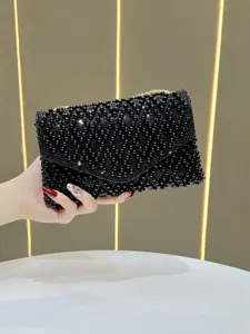 Black beaded rhinestone clutch bag detail shot, elegant evening handbag for party and events.