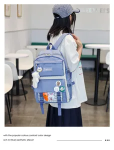 Casual student school backpack with stylish badges and cute pendant for daily use and travel.