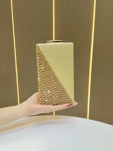 Elegant gold glitter evening clutch bag with rhinestone diamond detail for women parties.