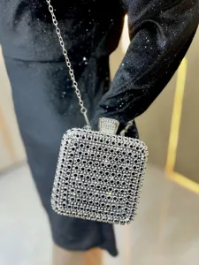 Crystal evening clutch bag detail showing sparkling rhinestones and silver metal chain strap.