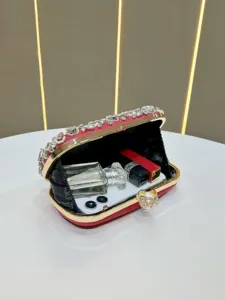 Detailed view of the red rhinestone evening clutch bag showcasing spacious interior capacity.