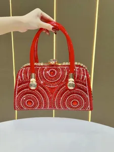 Luxurious red rhinestone evening bag with sparkling crystals and gold hardware, chic clutch.