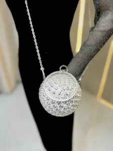Sparkling rhinestone spherical evening bag with elegant rose floral pattern and chain.