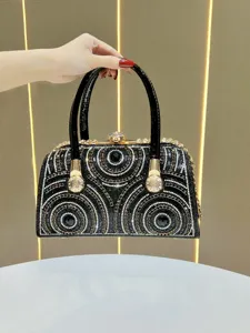Luxury rhinestone evening handbag, elegant black clutch with sparkling metallic gold hardware.