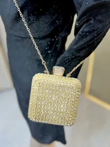 Glamorous gold rhinestone box clutch bag with chain strap, perfect for evening parties.