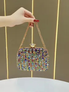 Detailed view of luxury crystal rhinestone evening clutch bag with golden chain strap for women.