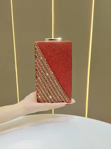 Detail view of the elegant red glitter evening clutch bag with stunning gold rhinestone pattern.