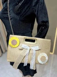 Chic straw woven shoulder bag detail, featuring cute sunflower and lace bow decorations.