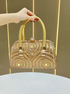 Luxurious gold rhinestone evening handbag, elegant women's clutch with chain and handle.