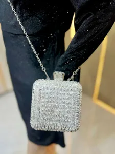Detailed shot of glittering rhinestone box clutch evening bag with silver chain strap party.