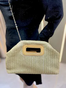 Woven straw crossbody bag for women, stylish summer beach handbag with chain strap and handle.