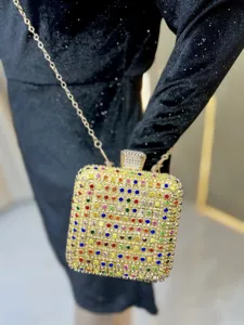Closeup view of a dazzling rhinestone evening clutch bag with colorful crystal details and chain.