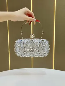 Detailed view of shimmering rhinestone evening clutch featuring crystals and metal handle.