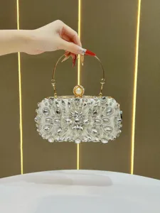 Elegant crystal evening clutch bag detail showing sparkling rhinestones and pearl clasp design.