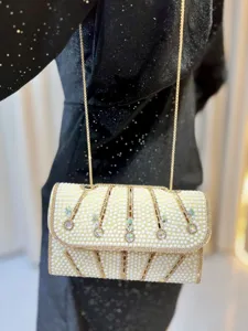 Elegant pearl rhinestone shoulder bag detail, luxury gold chain crossbody bag for women.