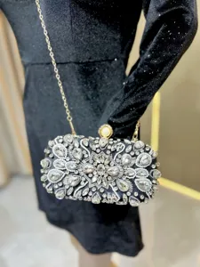 Exquisite rhinestone evening clutch bag detail showing sparkling crystals and pearl clasp.