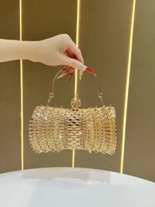 Elegant gold rhinestone evening clutch bag with sparkling crystals and metal top handle for women.