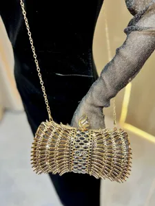 Exquisite rhinestone evening clutch bag with metallic chain strap for women party banquet wear.