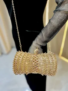 Elegant gold crystal evening clutch bag with chain strap for luxury party dresses and banquets.