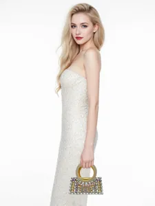 Close-up detail of the luxury rhinestone evening bag with elegant golden round handle.