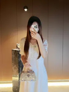 Vue détaillée du sac à main de soirée étincelant en strass avec poignée et breloques.