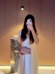 Silver metallic evening clutch bag, elegant minimalist design for parties and formal events.
