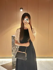 Elegant black evening clutch bag with golden chain, stylish crossbody bag for women.