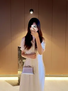 Silver metallic evening clutch bag detail, elegant chain shoulder bag for women style.