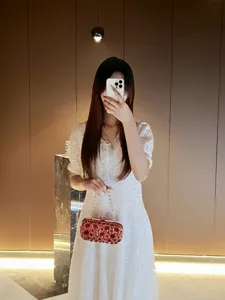 Exquisite red rhinestone evening clutch bag with chain strap for luxury party wedding dress.