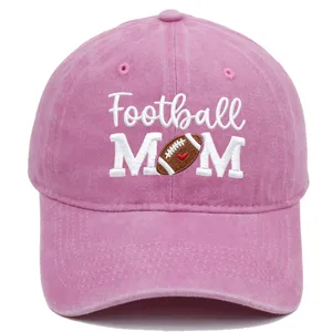 Close-up detail of pink washed baseball cap featuring embroidered football mom text design.