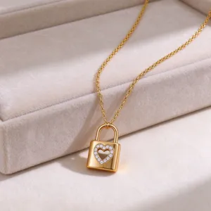 Close-up detail of the elegant gold lock pendant necklace with heart cutout stones.