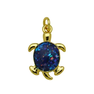 Gold-colored turtle pendant necklace accessory with blue sparkling shell inlay style.